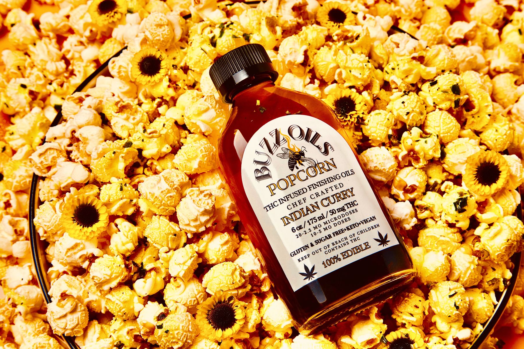 Buzz Oils Popcorn in a bed of popcorn