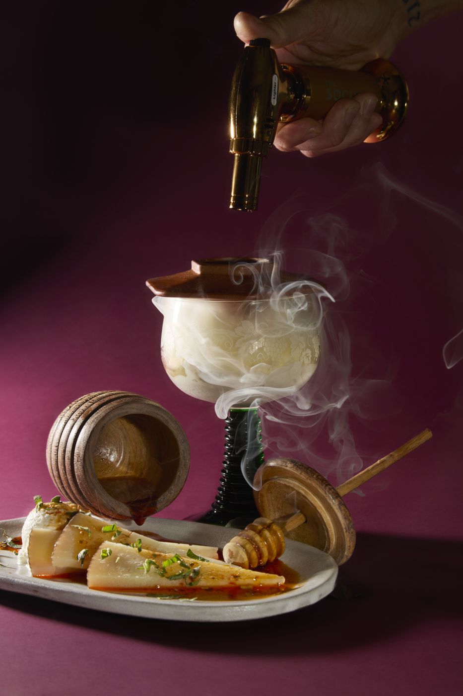 Oil poured over a smoking cocktail glass