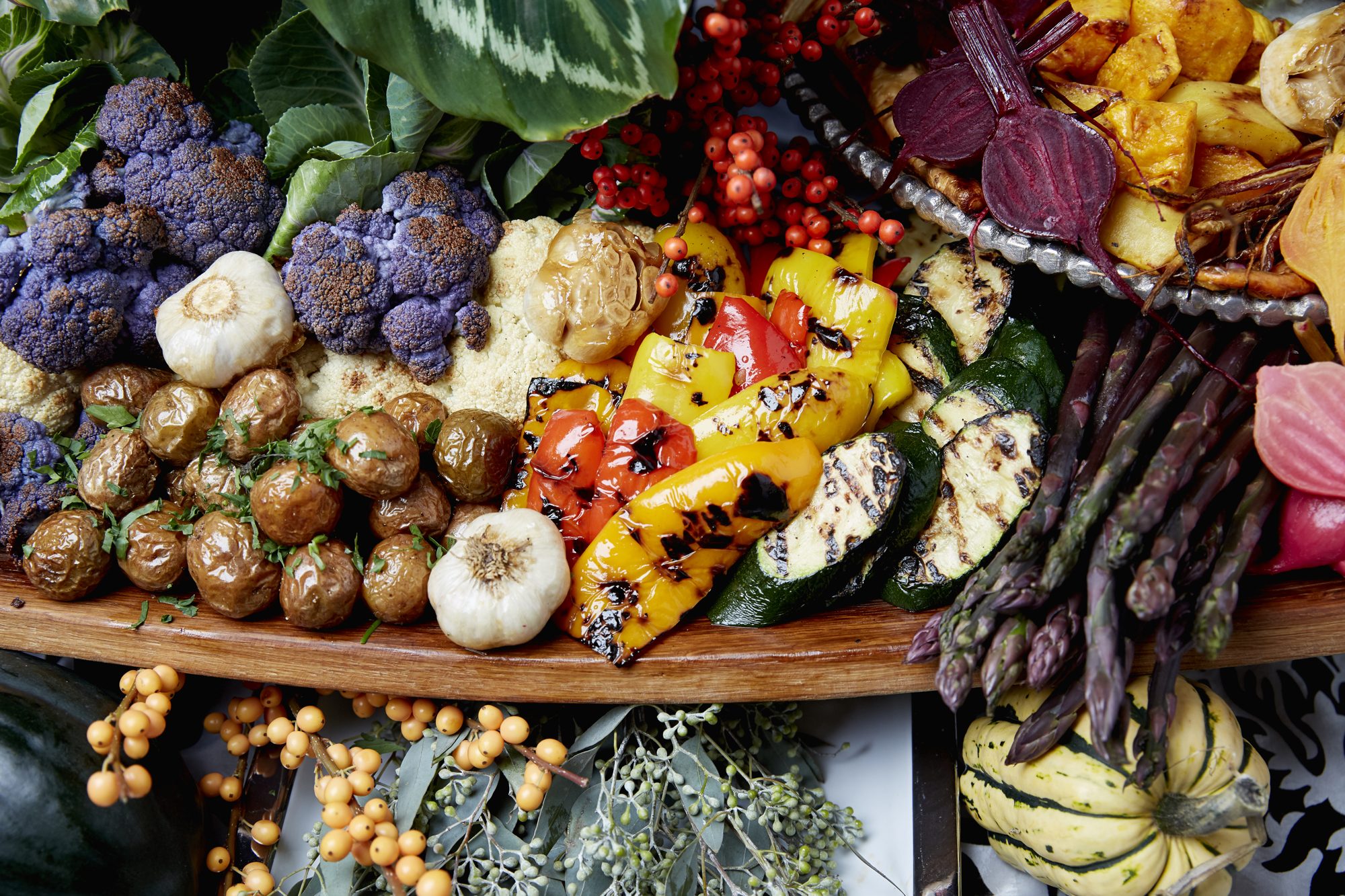 A roasted vegetable board with purple cauliflower