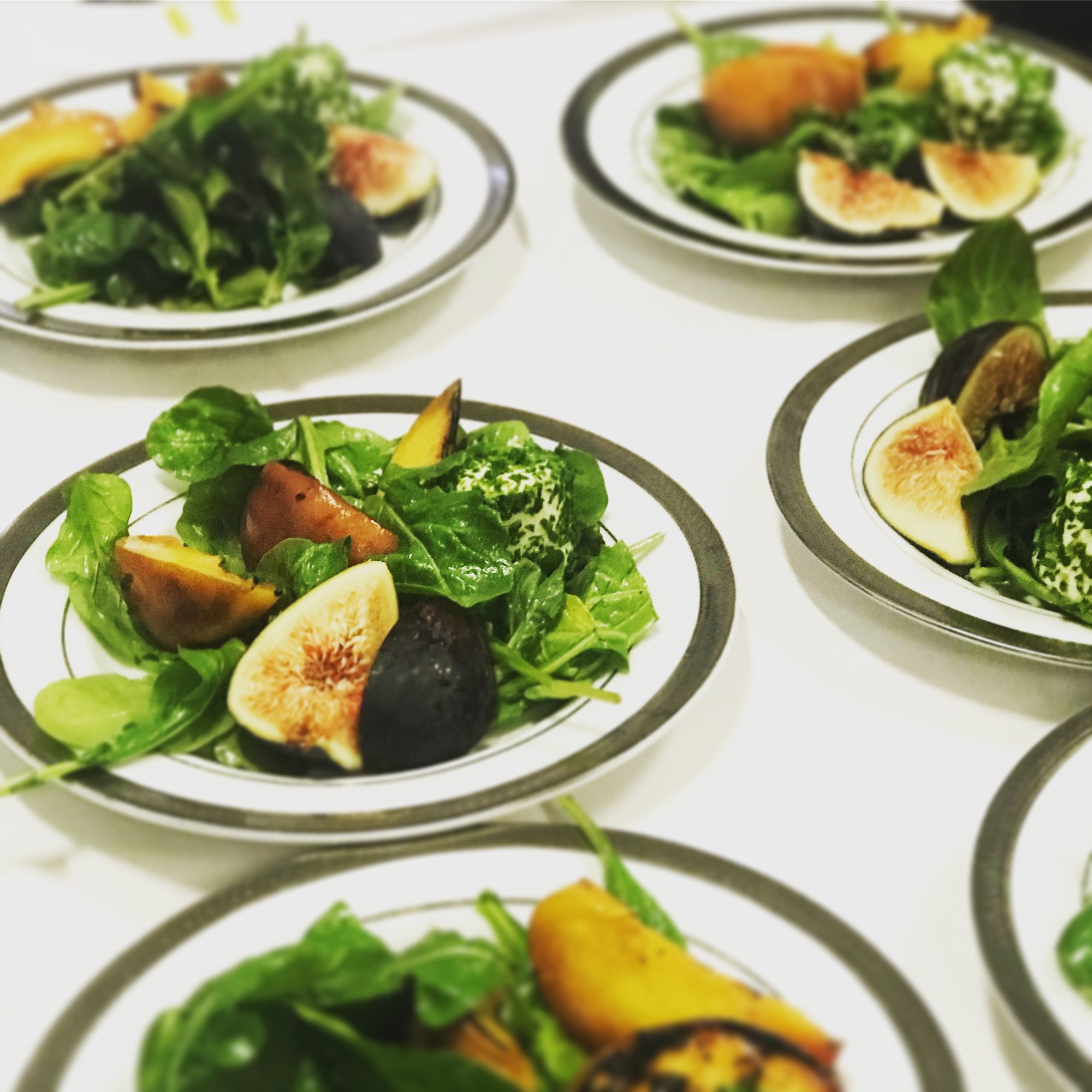 Fig and greens salads plated for a dinner