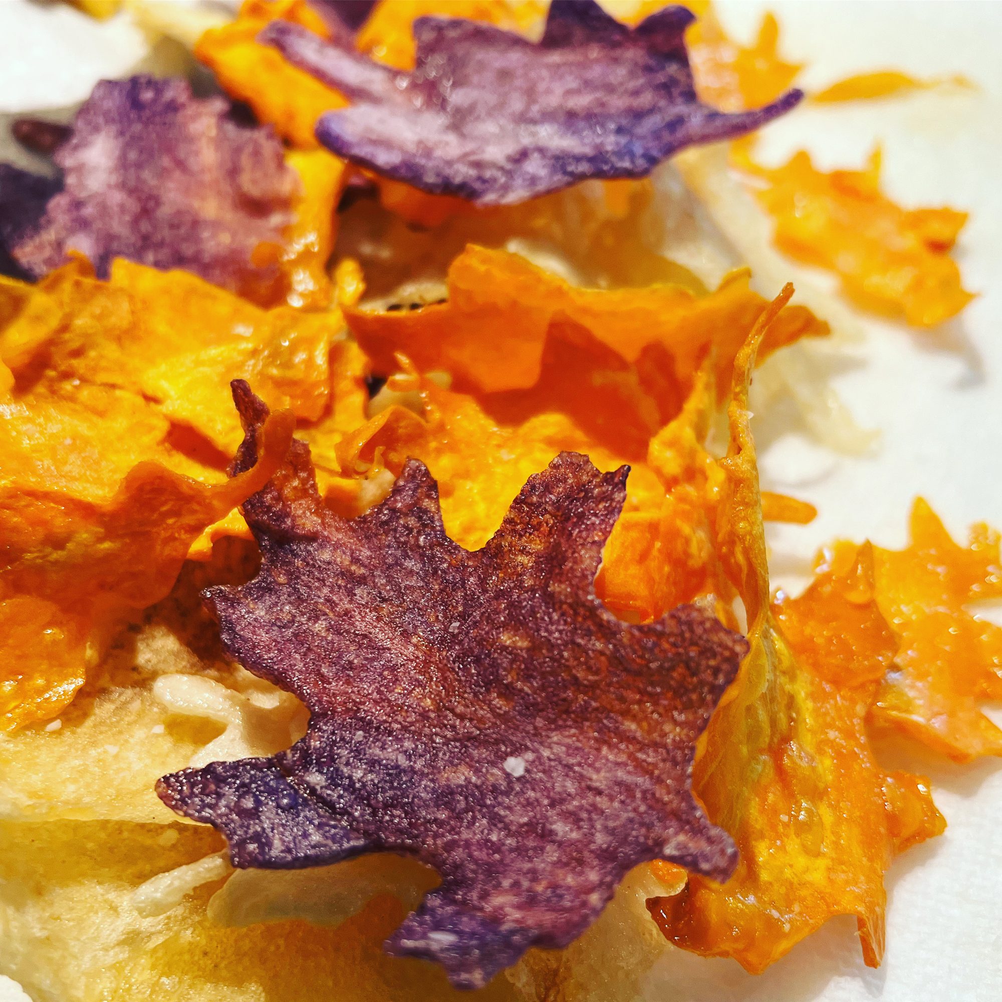 Leaf-shaped purple and orange vegetable chips